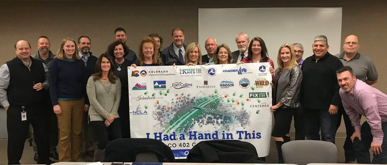 Colleen Whitlow with regional leaders holding an “I Had a Hand in This” North I-25 banner